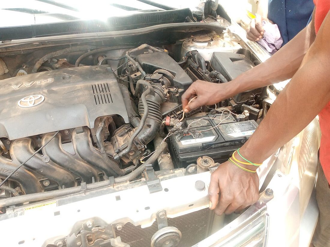 A 12-volt car battery installed in an engine bay