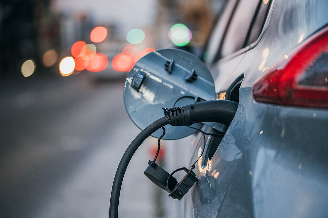 Close-up of an electric car plugged in and charging