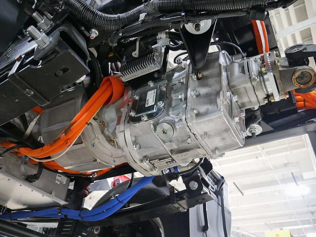 An electric drive unit with thick orange high-voltage cables