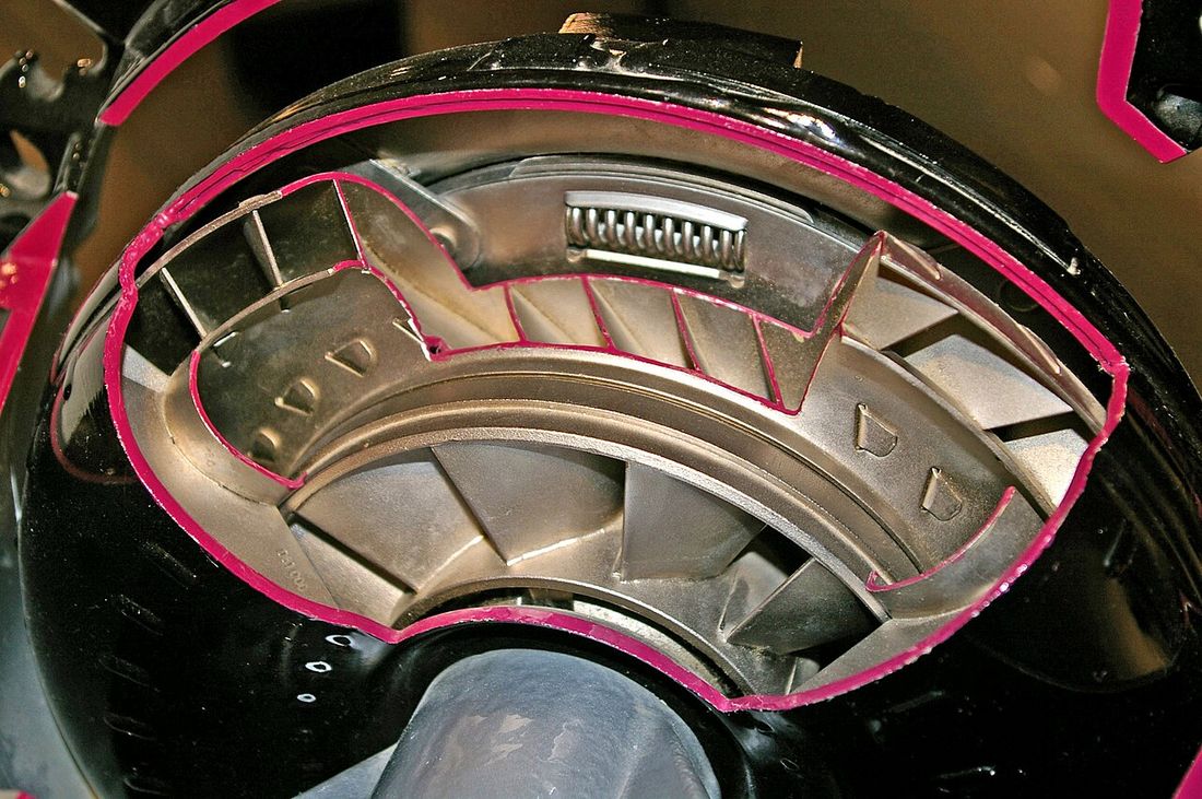 A cutaway model of a torque converter showing the fan-like blades inside