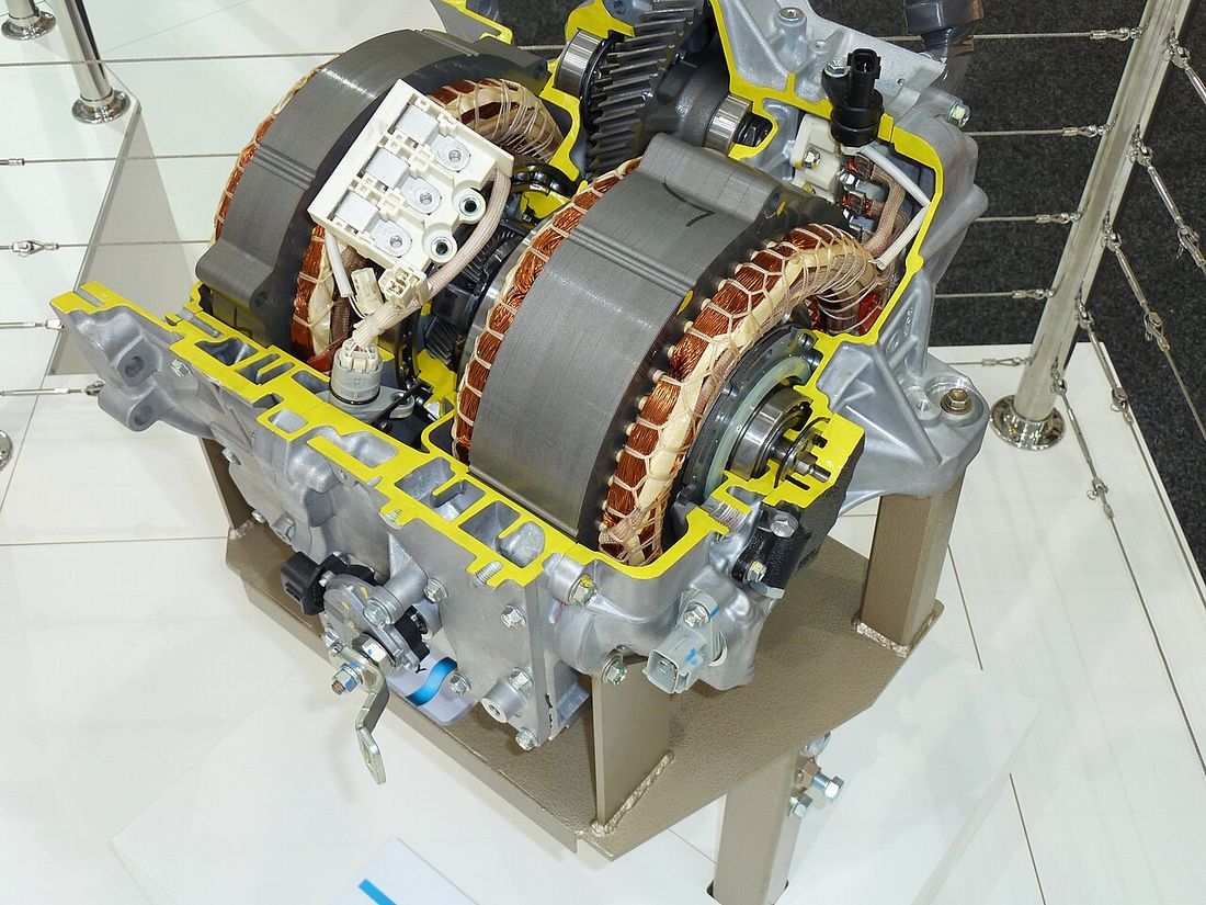 A cutaway hybrid transaxle showing two large electric motor windings