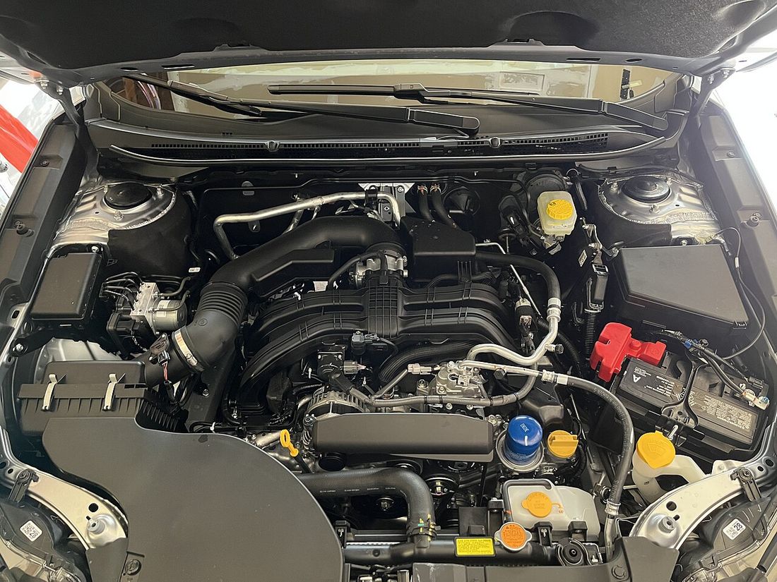 A modern engine bay showing the coolant reservoir and hoses