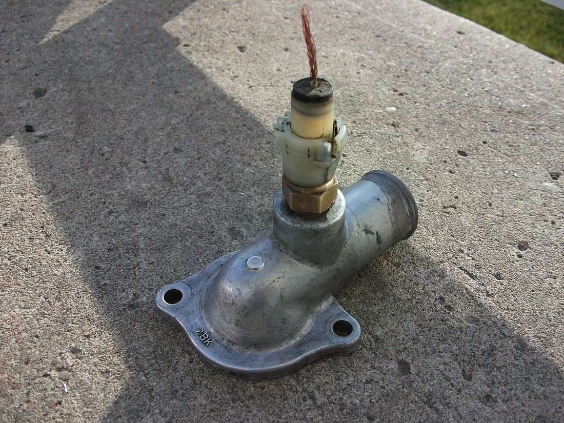 A thermostat housing with a new thermostat fitted