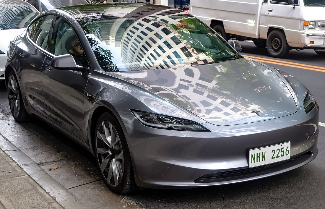 A modern electric saloon car parked on a city street