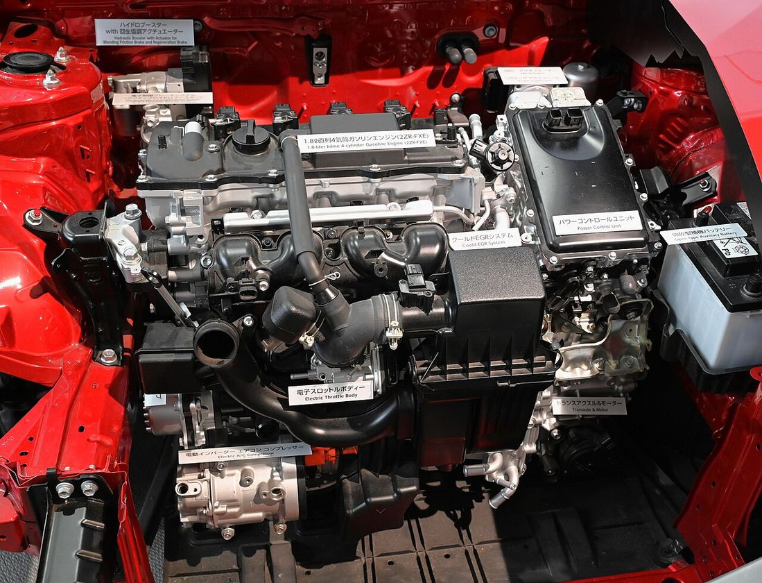 Cutaway display of a hybrid car showing its engine, motor and battery layout