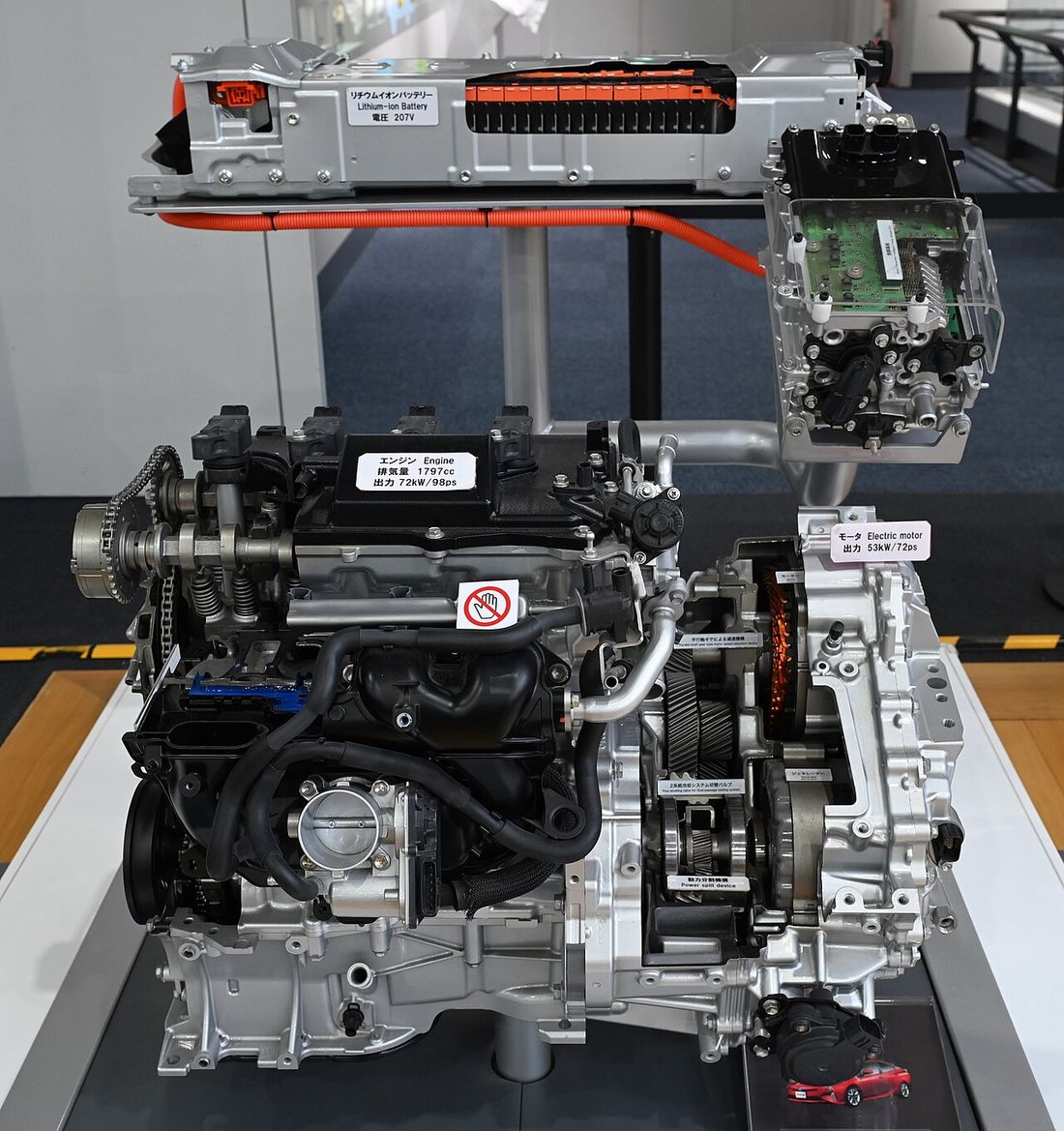 A hybrid system on display: battery at the top, inverter, engine and electric motor