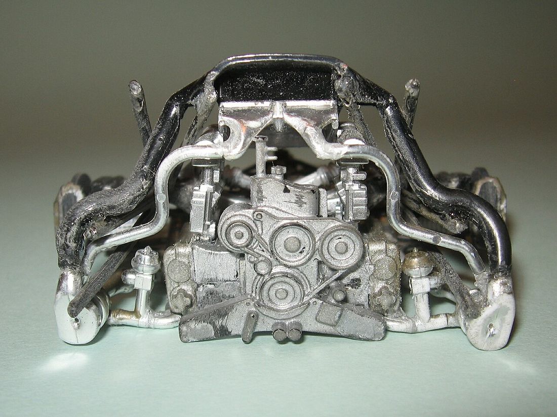 The front of an engine showing the serpentine belt, pulleys and turbochargers