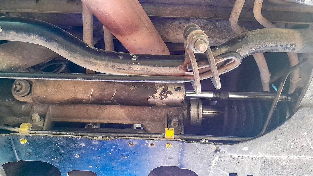 A power steering pump and reservoir in an engine bay
