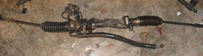 A steering rack with its pinion housing and track rods